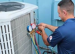 Technician checking manifold pressure gauges on an outdoor condenser